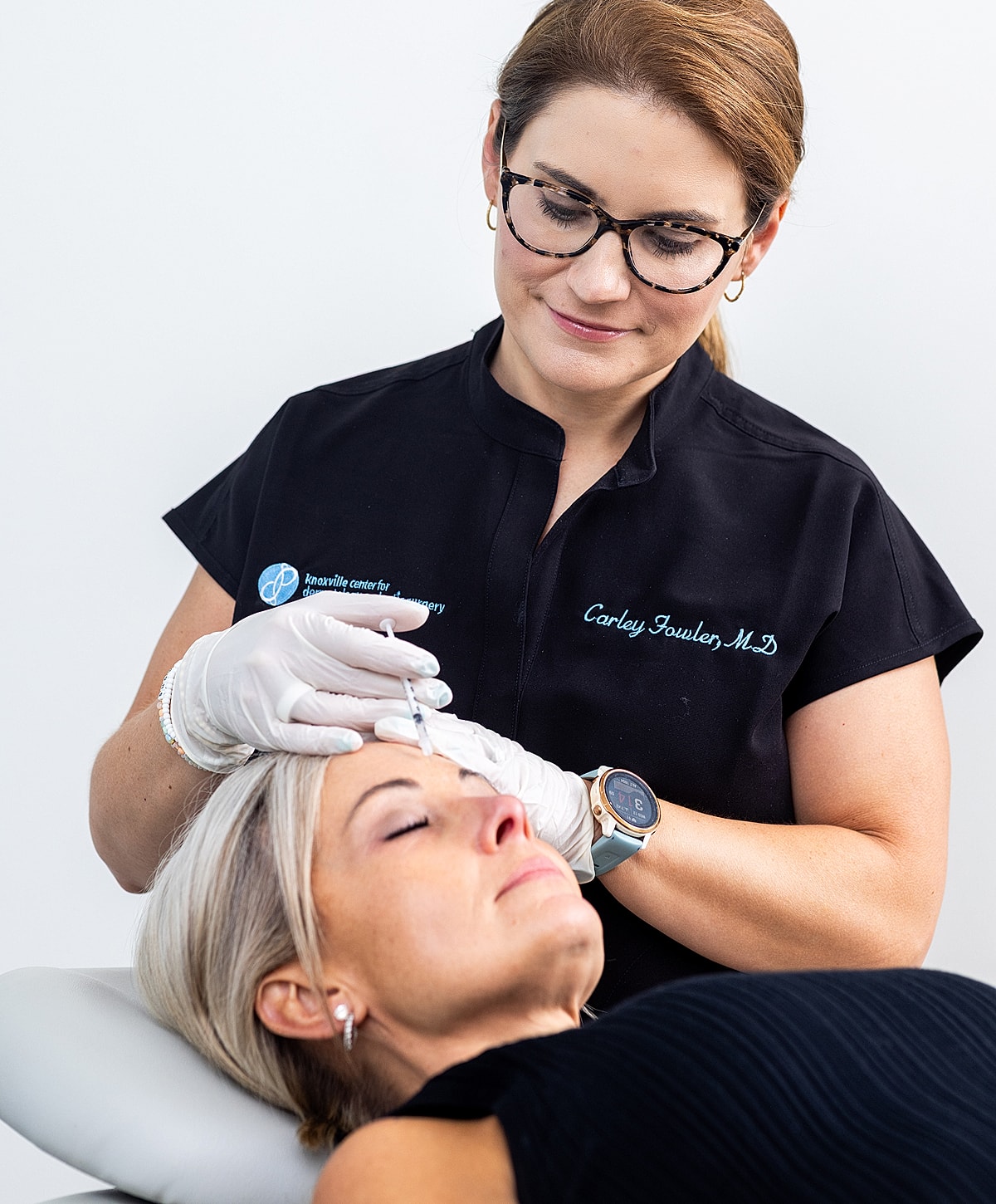 Doctor administering cosmetic treatment to a patient.