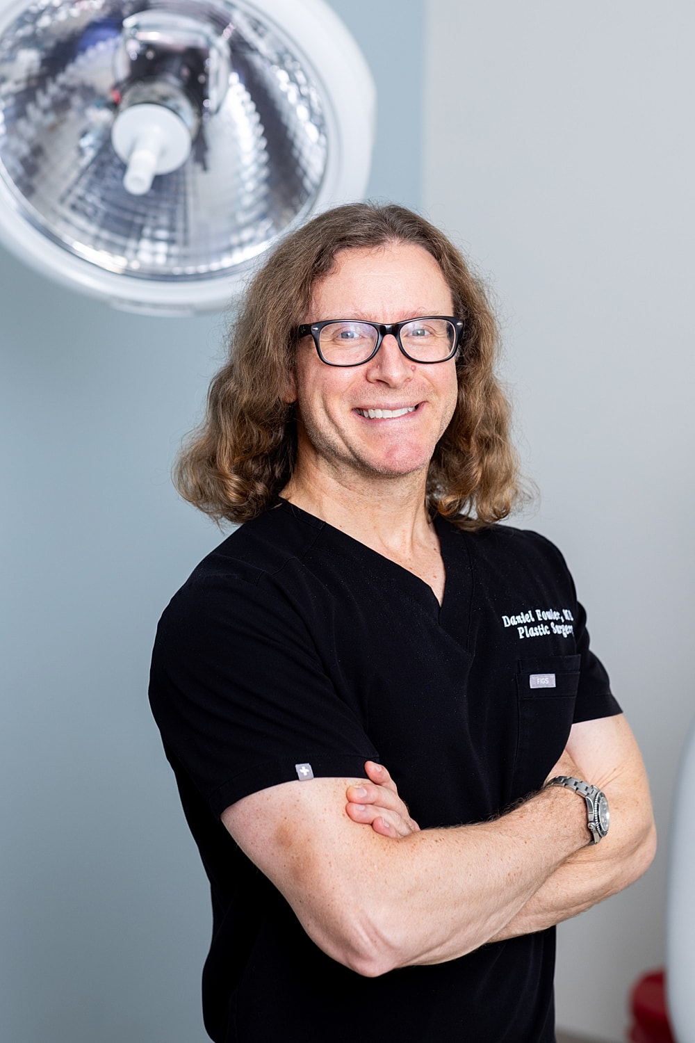Smiling doctor in surgical attire portrait.